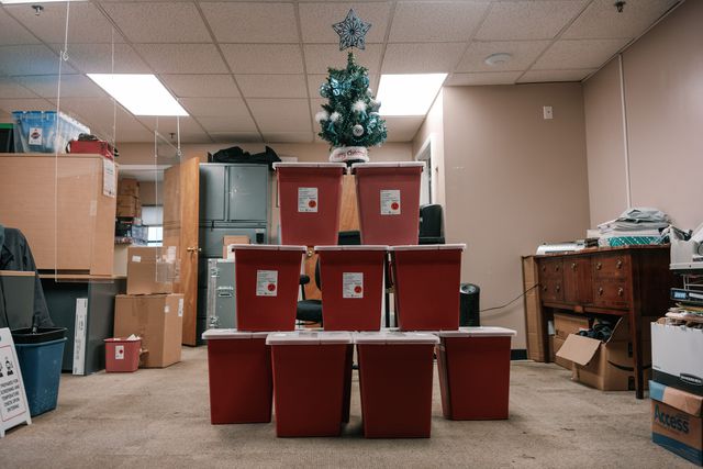 A small Christmas tree is perched atop a stack of boxes containing used syringes, cookers, gauze and other hazardous waste collected at the overdose prevention site in Harlem. Staff said if not for their center, this waste could have ended up on the street.